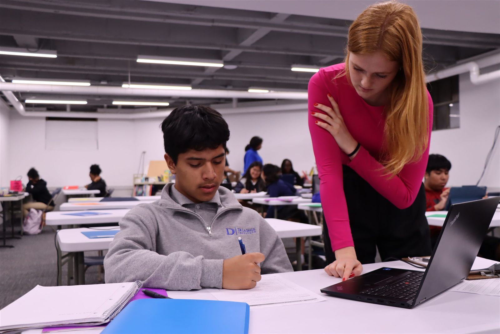 A HighSight tutor working one-on-one with a student